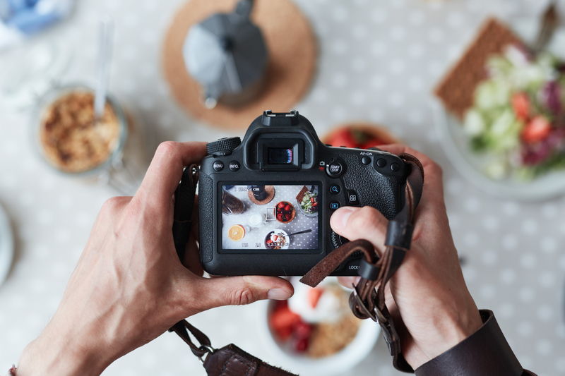 Taking a photo of food on the table 